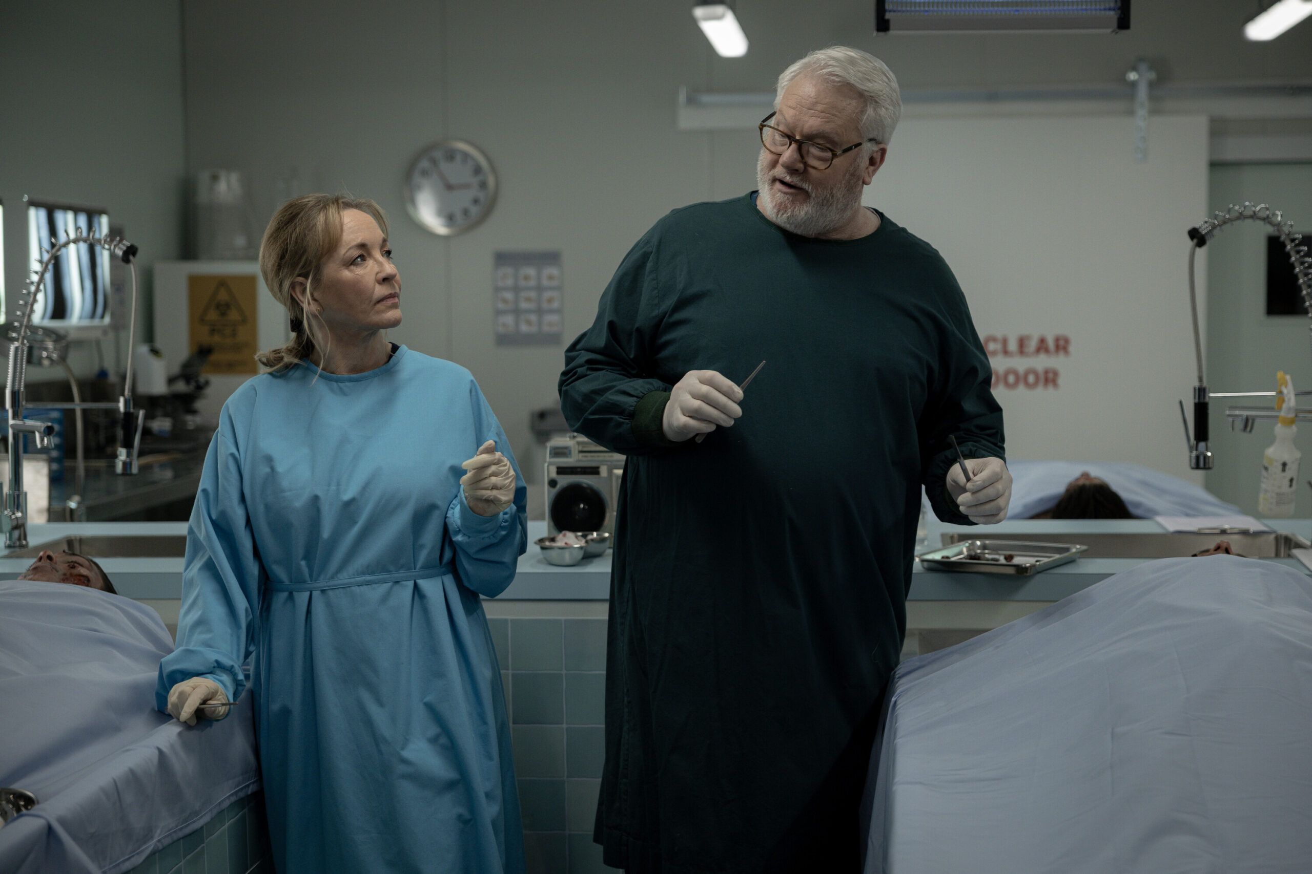 NCIS: Sydney Season 3 Episode 12, "Lone Wolf: Part One" -- Rebecca Gibney as Nia Williams and William McInnes as Forensic Pathologist Dr. Roy Penrose