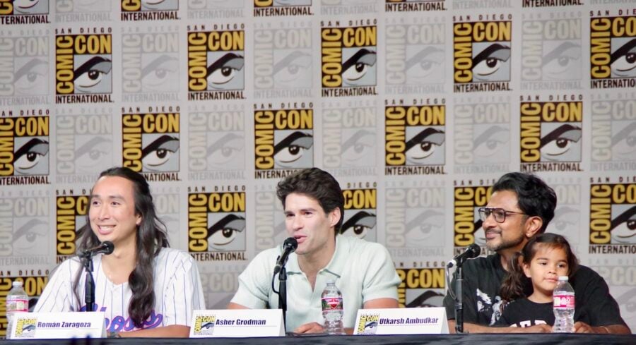 Ghosts Comic-Con Panel 2026 — Román Zaragoza (Sasappis), Asher Grodman (Trevor), and Utkarsh Ambudkar (Jay). Photo courtesy of Alicia Gilstorf. | Tell-Tale TV Ghosts Comic-Con Panel 2026 — Joe Wiseman, Joe Port, Román Zaragoza (Sasappis), Asher Grodman (Trevor), and Utkarsh Ambudkar (Jay). Photo courtesy of Alicia Gilstorf. Everything the Ghosts Showrunners and Cast Revealed at Comic-Con About Season 6