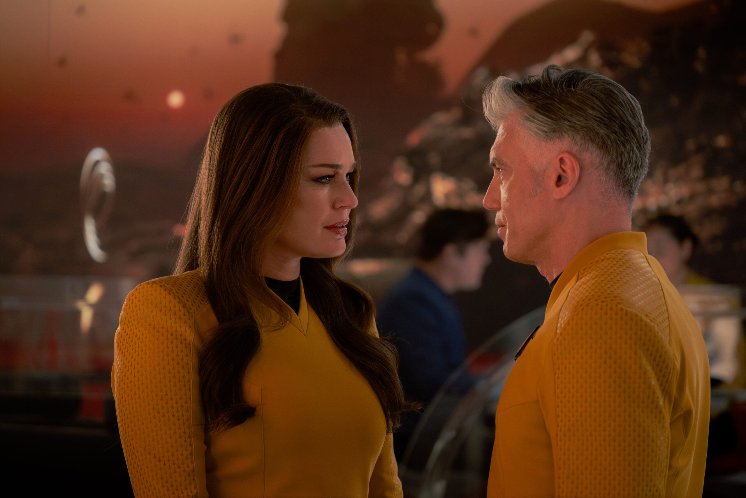 Star Trek: Strange New Worlds Season 4 Episode 7 - Rebecca Romijn and Anson Mount | Tell-Tale TV Still from Star Trek: Strange New Worlds Season 4 Episode 7 of Rebecca Romijn as Una and Anson Mount as Captain Pike pictured from left to right. Star Trek: Strange New Worlds Season 4 Episode 7 Preview: General Enterprise Still from Star Trek: Strange New Worlds Season 4 Episode 7 of Rebecca Romijn as Una and Anson Mount as Captain Pike pictured from left to right.