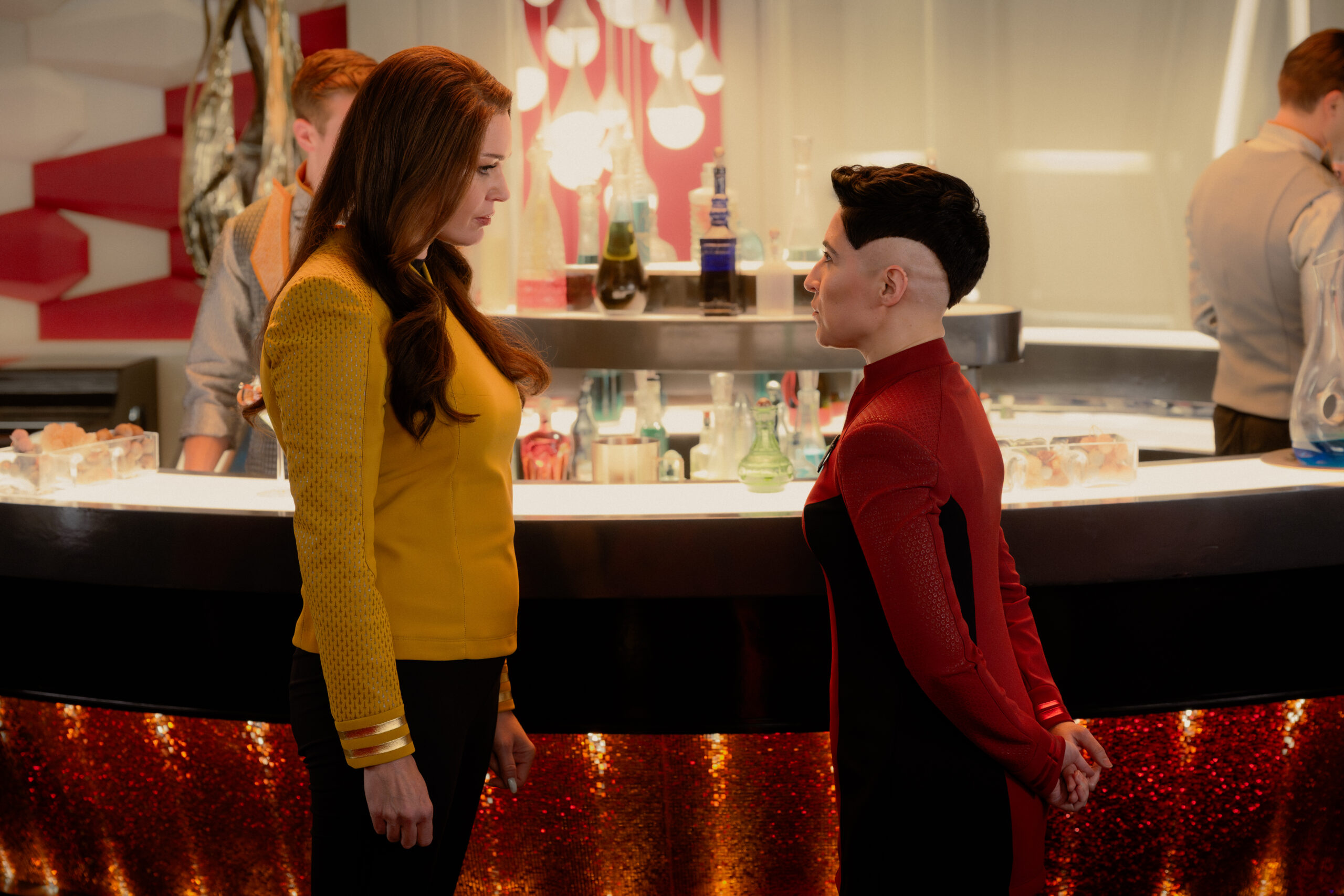 Star Trek: Strange New Worlds Season 4 Episode 7 - Rebecca Romijn and Melissa Navia | Tell-Tale TV Still from Star Trek: Strange New Worlds Season 4 Episode 7 of Rebecca Romijn as Una and Melissa Navia as Lt. Erica Ortegas pictured from left to right. Star Trek: Strange New Worlds Season 4 Episode 7 Preview: General Enterprise Still from Star Trek: Strange New Worlds Season 4 Episode 7 of Rebecca Romijn as Una and Melissa Navia as Lt. Erica Ortegas pictured from left to right.