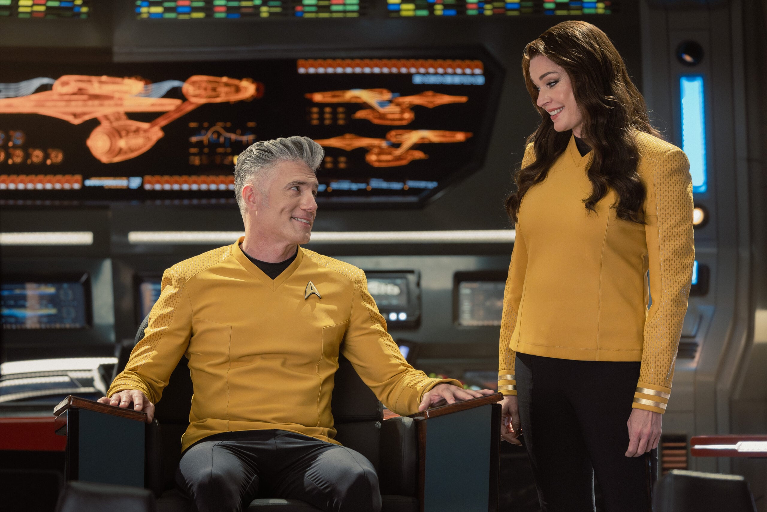 Still from Star Trek: Strange New Worlds Season 4 Episode 5 of Anson Mount as Captain Pike and Rebecca Romijn as Una pictured from left to right. Star Trek: Strange New Worlds Season 4 Episode 5 Preview: Brought to You by The Letter P Still from Star Trek: Strange New Worlds Season 4 Episode 5 of Anson Mount as Captain Pike and Rebecca Romijn as Una pictured from left to right.