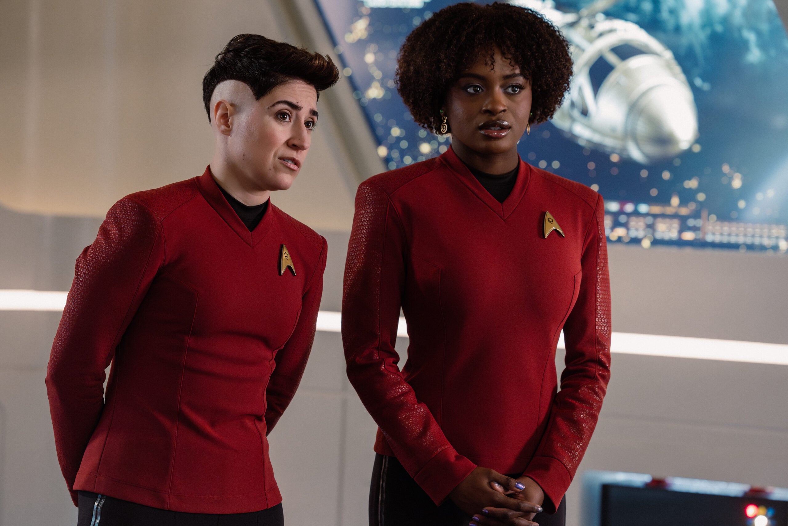 Star Trek: Strange New Worlds Season 4 Episode 6 - Melissa Navia and Celia Rose Gooding | Tell-Tale TV Still from Star Trek: Strange New Worlds Season 4 Episode 6 of Melissa Navia as Lt. Erica Ortegas and Celia Rose Gooding as Uhura pictured from left to right. Star Trek: Strange New Worlds Season 4 Episode 6 Preview: Need for Speed Still from Star Trek: Strange New Worlds Season 4 Episode 6 of Melissa Navia as Lt. Erica Ortegas and Celia Rose Gooding as Uhura pictured from left to right.