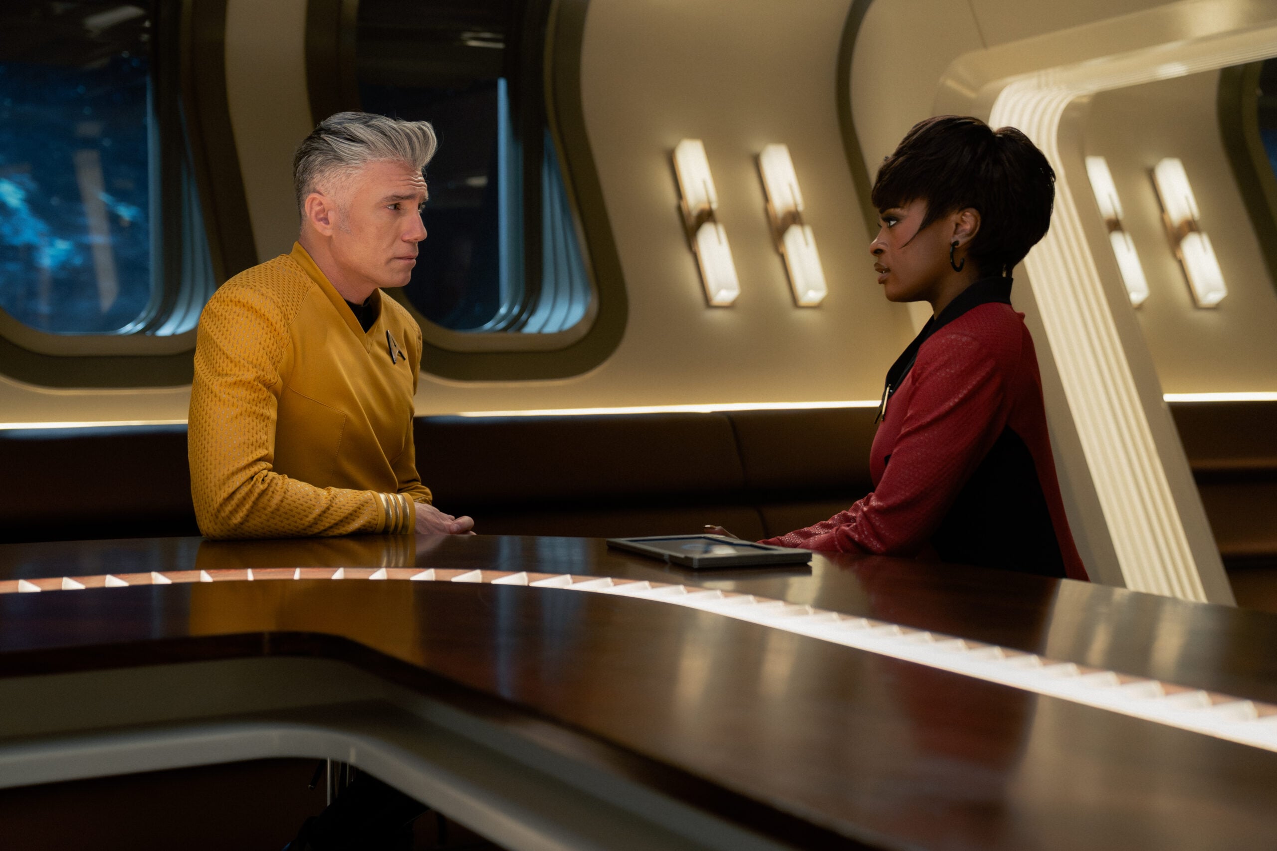 Star Trek: Strange New Worlds Season 4 Episode 10 - Anson Mount and Celia Rose Gooding | Tell-Tale TV Still from Star Trek: Strange New Worlds Season 4 Episode 10 of Anson Mount as Captain Pike and Celia Rose Gooding as Uhura pictured from left to right. Star Trek: Strange New Worlds Season 4 Episode 10 Preview: A Timey Wimey Finale Still from Star Trek: Strange New Worlds Season 4 Episode 10 of Anson Mount as Captain Pike and Celia Rose Gooding as Uhura pictured from left to right.