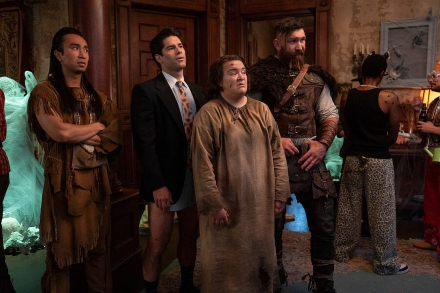 GHOSTS "Halloween 6: The Mirror - Part One" Pictured (L-R): Román Zaragoza as Sasappis, Asher Grodman as Trevor, Betsy Sodaro as Nancy, and Devan Chandler Long as Thor. Photo: Bertrand Calmeau/CBS ©2026 CBS Broadcasting, Inc. All Rights Reserved. | Tell-Tale TV GHOSTS "Halloween 6: The Mirror - Part One" Pictured (L-R): Román Zaragoza as Sasappis, Asher Grodman as Trevor, Betsy Sodaro as Nancy, and Devan Chandler Long as Thor. Photo: Bertrand Calmeau/CBS ©2026 CBS Broadcasting, Inc. All Rights Reserved. Ghosts Season 6 Episodes 1 and 2 Review: Séance and Sensibility